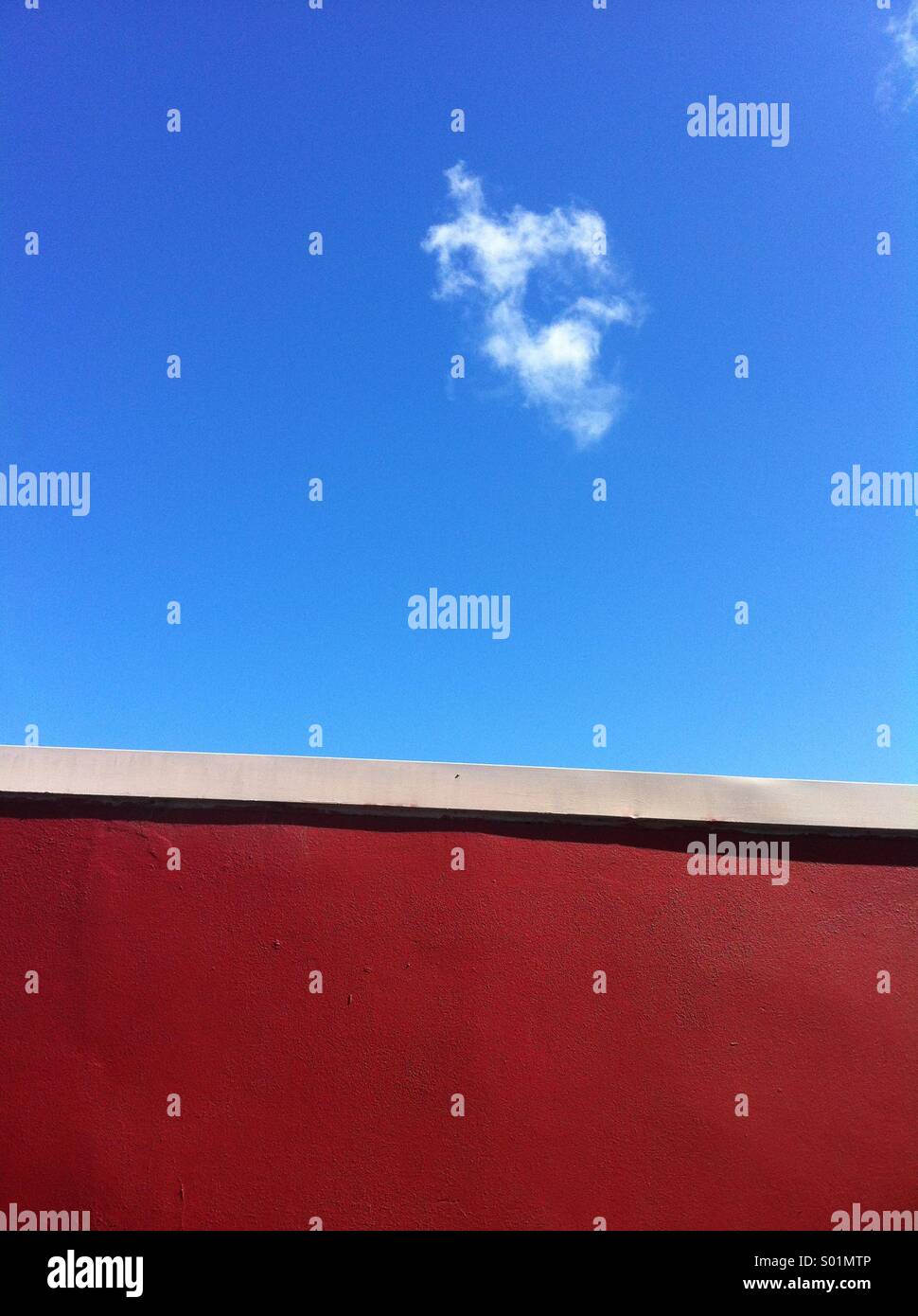 Red wall and blue sky with cloud Stock Photo