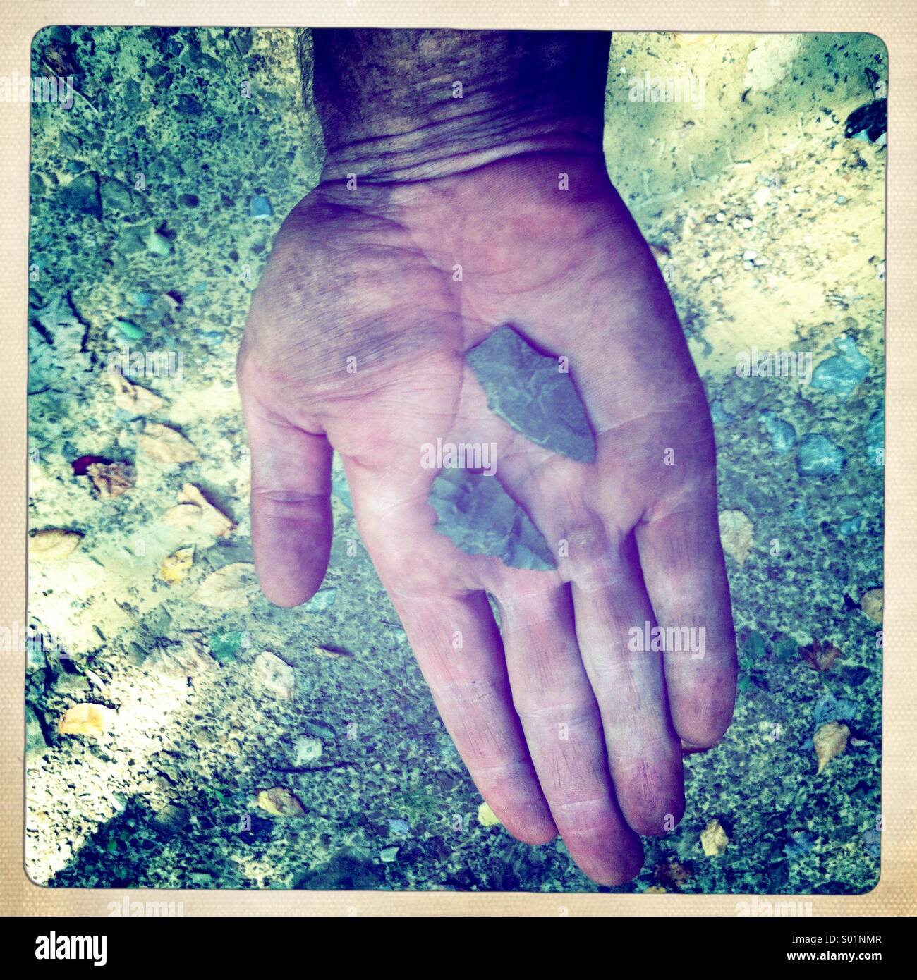 Two recently found arrowheads in hand. - Smartphone Captured Stock Image