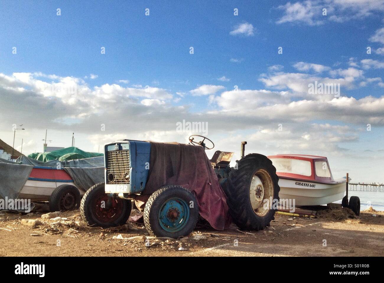 A tractor and fishing boat on a summers evening. Saltburn, UK - Smartphone Captured Stock Image