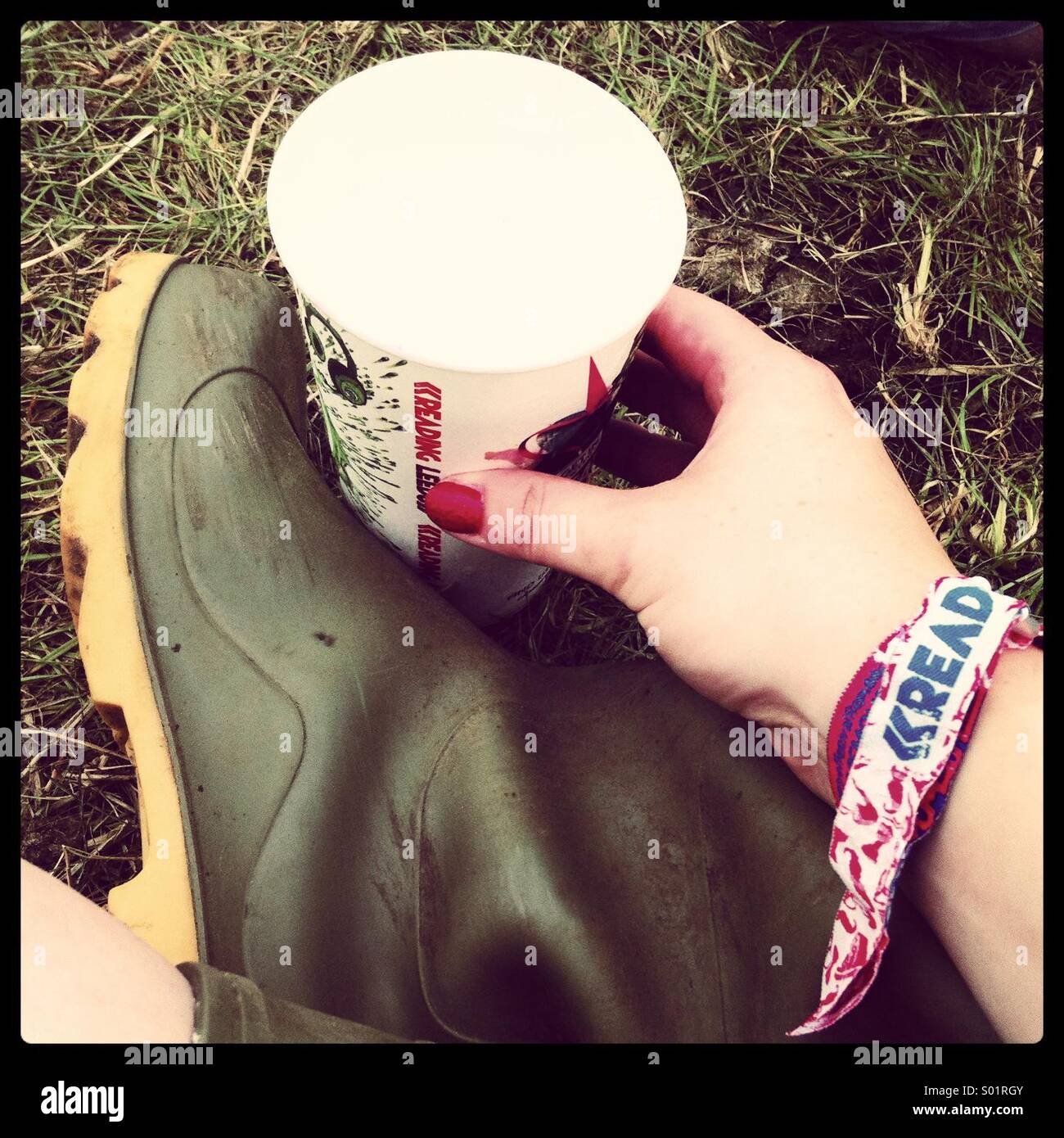 Reading Festival essentials-wellies, beer and wristband - Smartphone Captured Stock Image