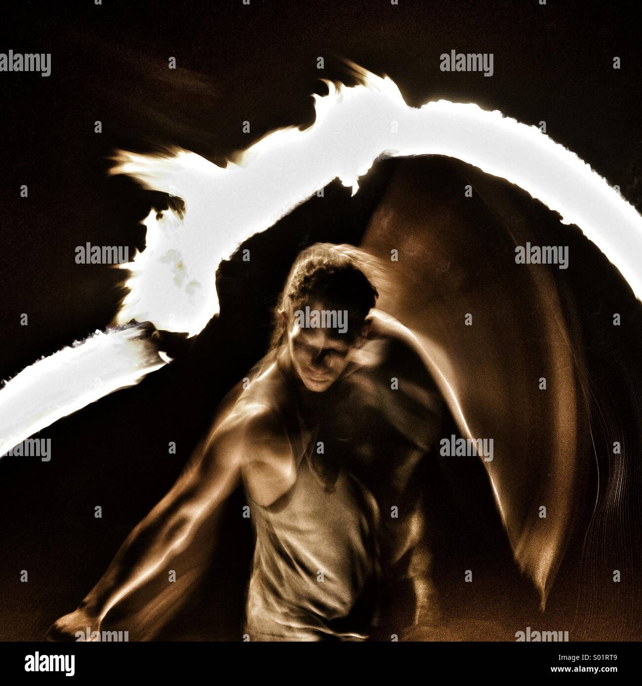 A busker performs a fire juggling act on the south bank of the Thames - Smartphone Captured Stock Image