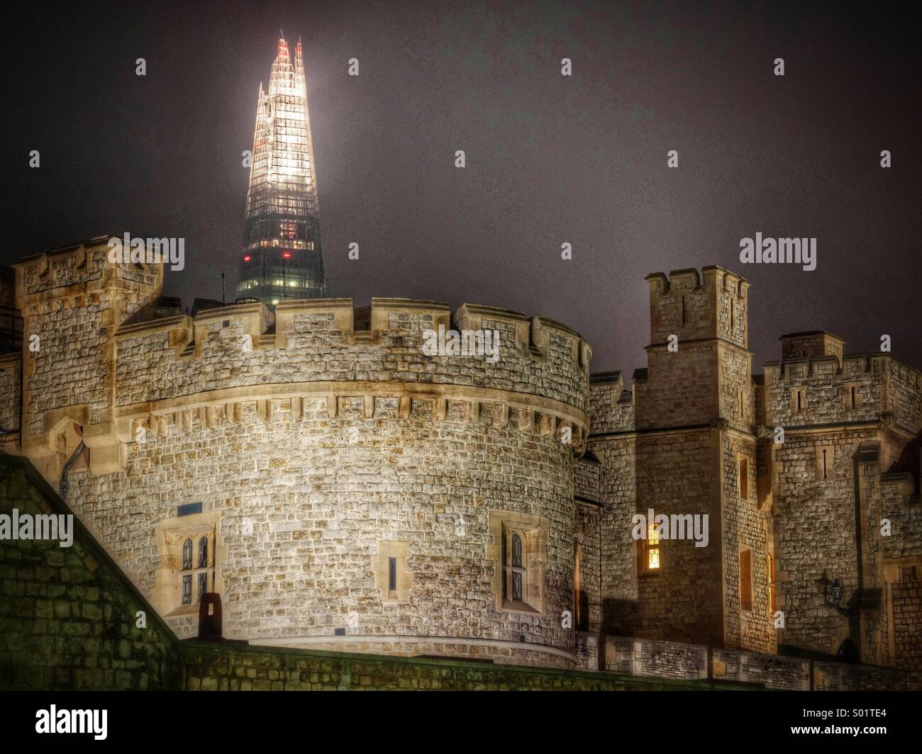Tower of London at night with the Shard skyscraper behind it - juxtaposition of ancient and modern - Smartphone Captured Stock Image