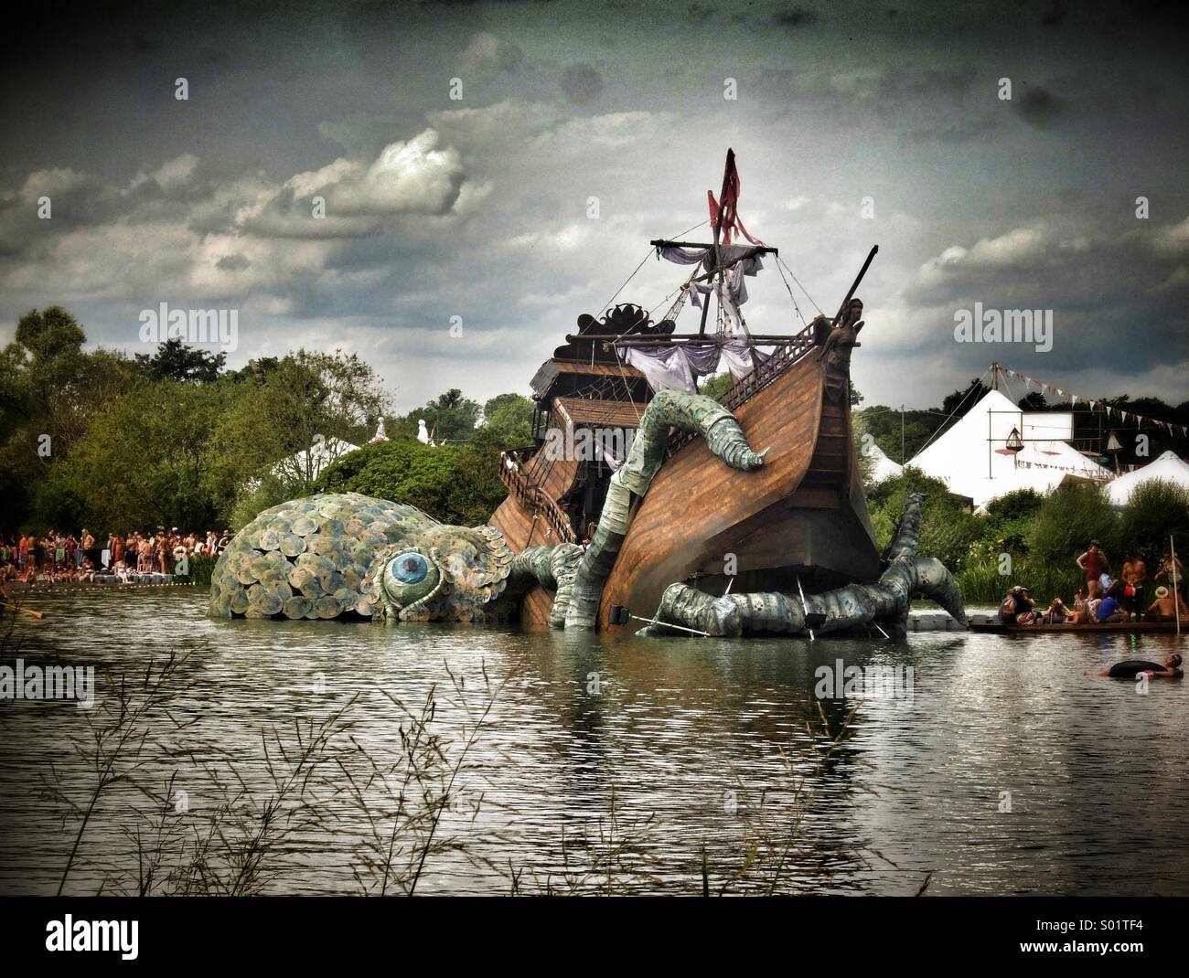 Octopus attacking a sailing ship... well, a very good life size model at The Secret Garden Party festival. - Smartphone Captured Stock Image