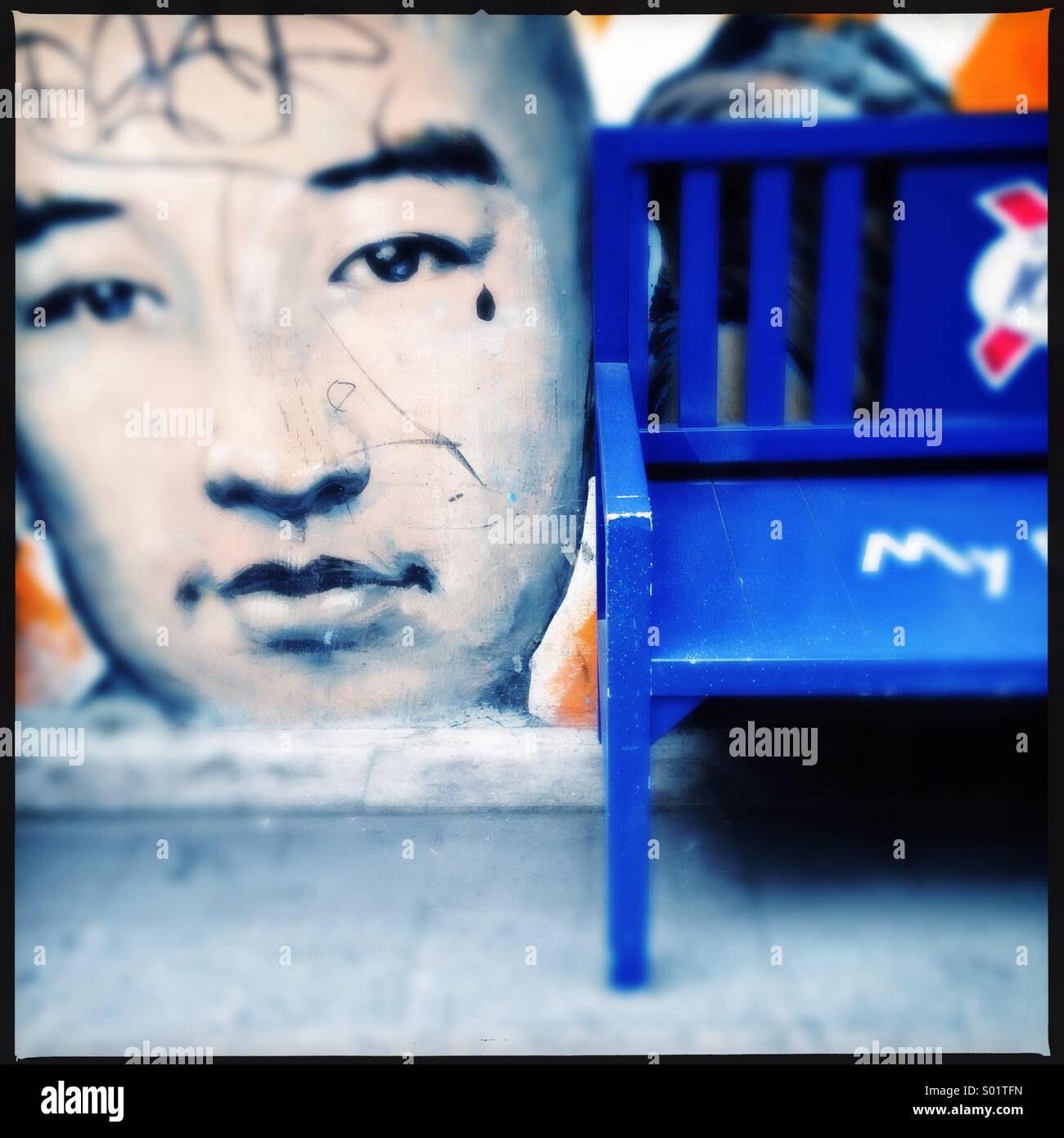 A bank in front of street graffiti - Smartphone Captured Stock Image
