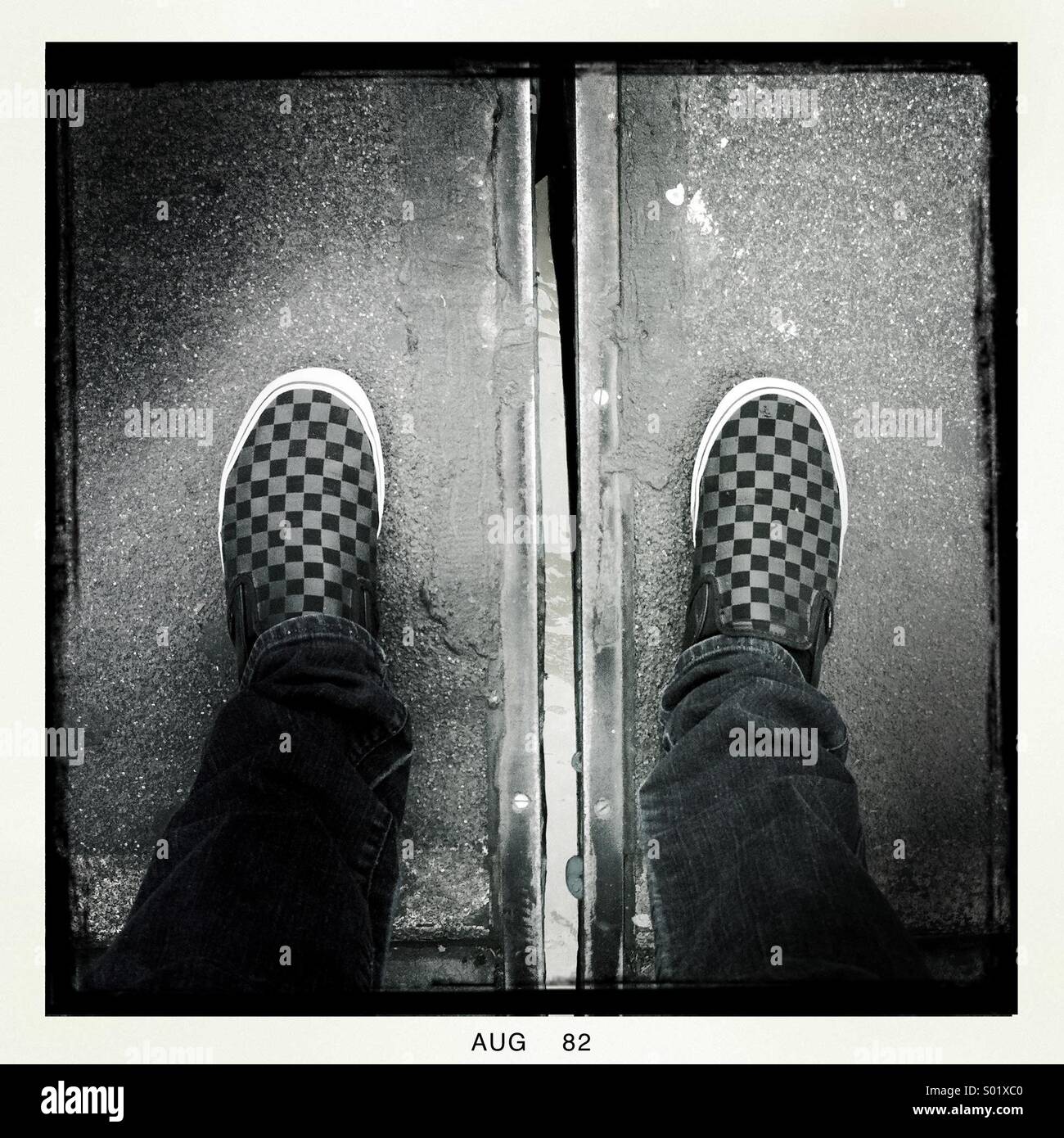 Looking down at checkered shoes - Smartphone Captured Stock Image