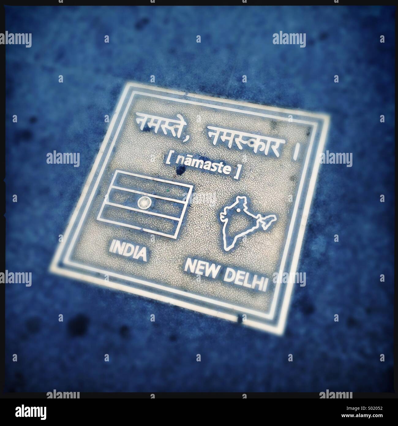 Brass plate on sidewalk showing 'hello' in in Indian. Seoul,Korea - Smartphone Captured Stock Image