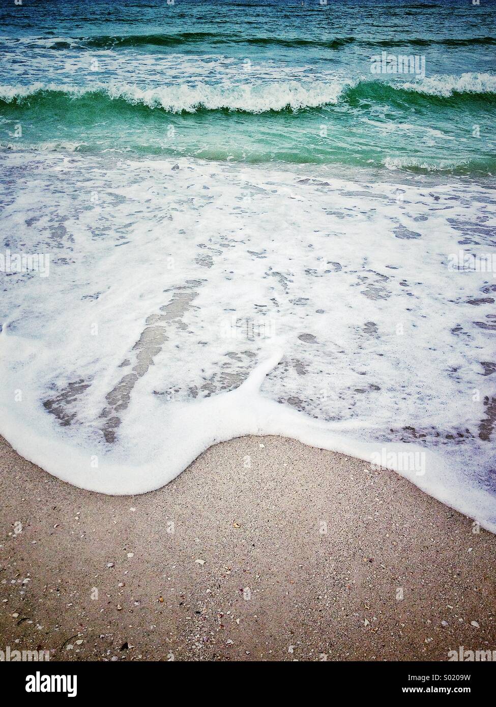 Ocean wave breaking at sandy shore at st. Pete's beach on the Gulf of Mexico Florida Stock Photo