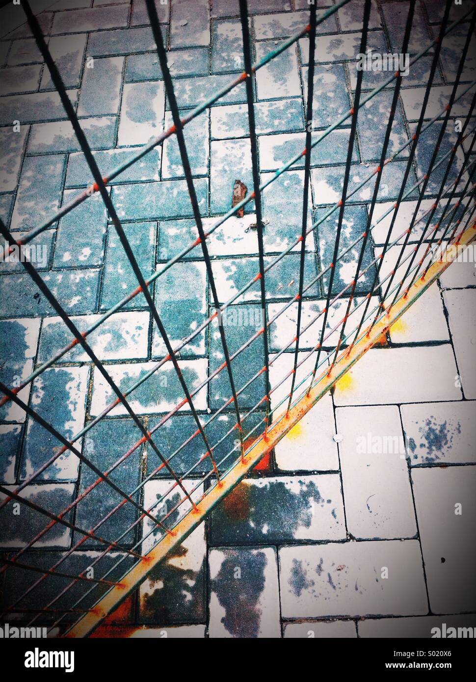 Metal wire temporary fencing on top of paving stones at construction site. British Columbia, Canada. - Smartphone Captured Stock Image