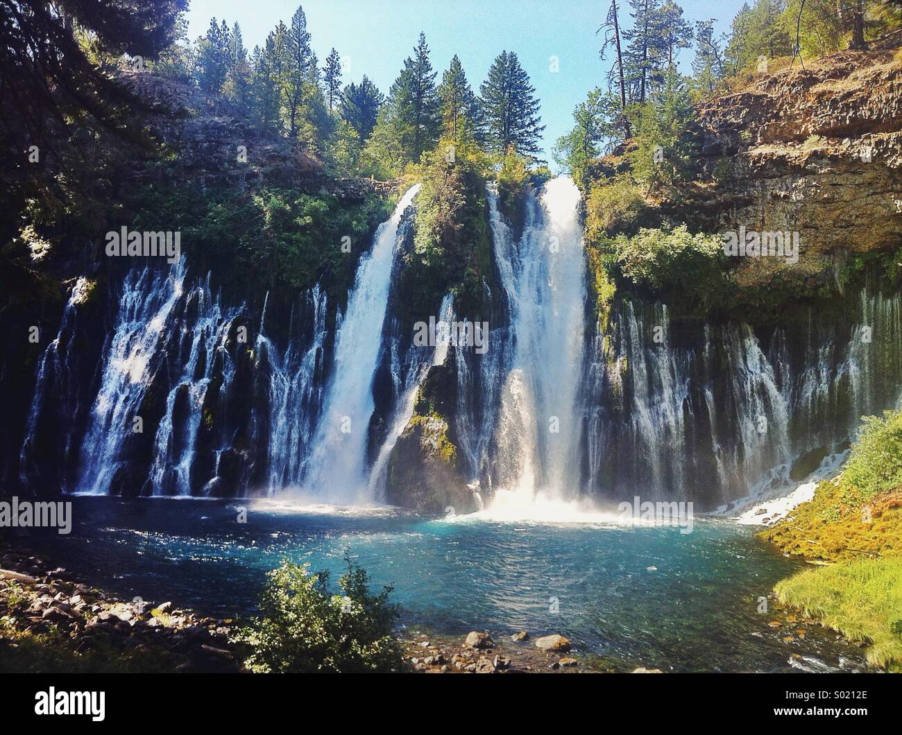 Burney Falls, is a waterfall on Burney Creek, in McArthur-Burney Falls Memorial State Park, Shasta County, California. Stock Photo