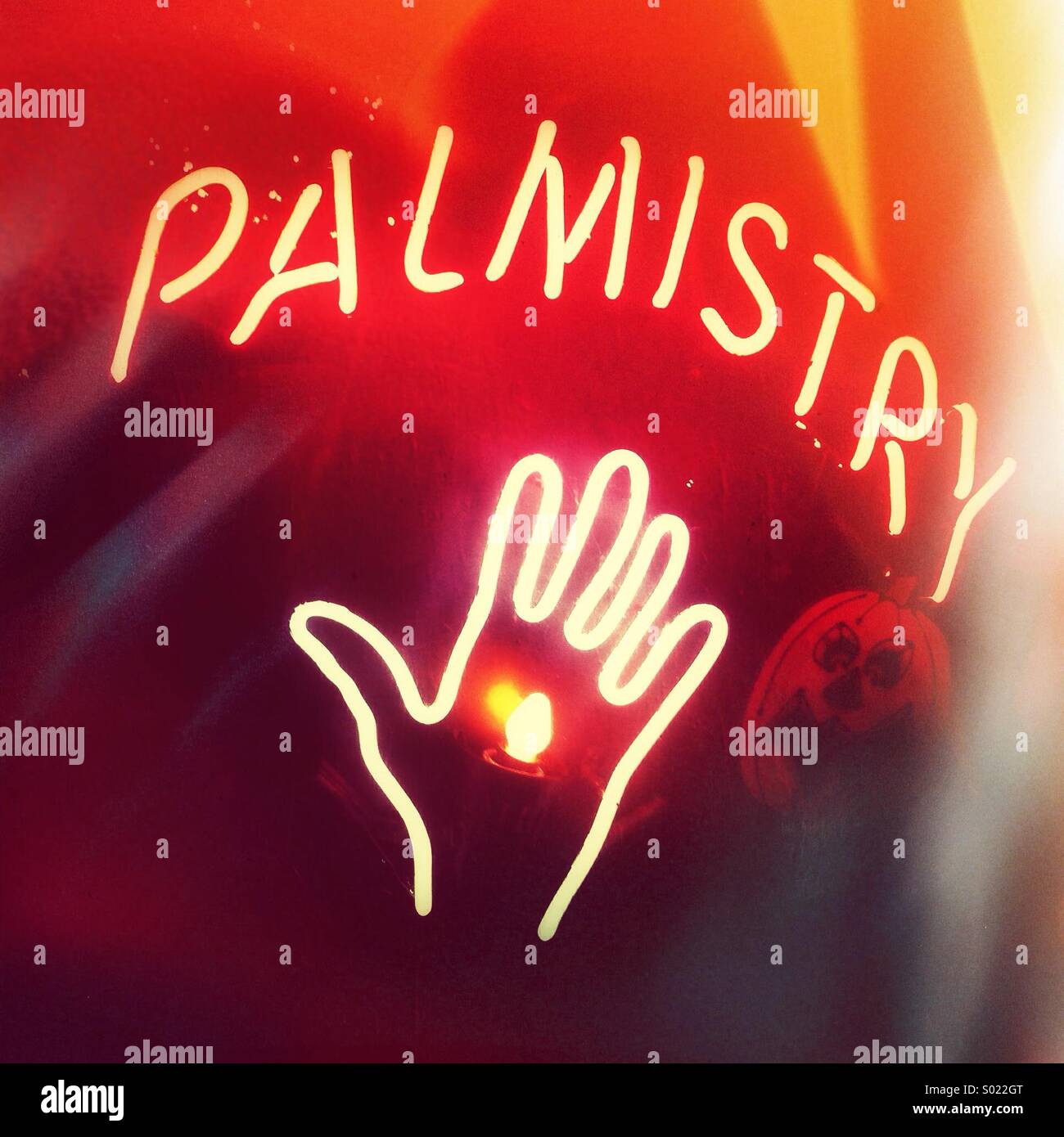 Neon fortune teller sign in window at night during Hallowe'en season, North America. - Smartphone Captured Stock Image