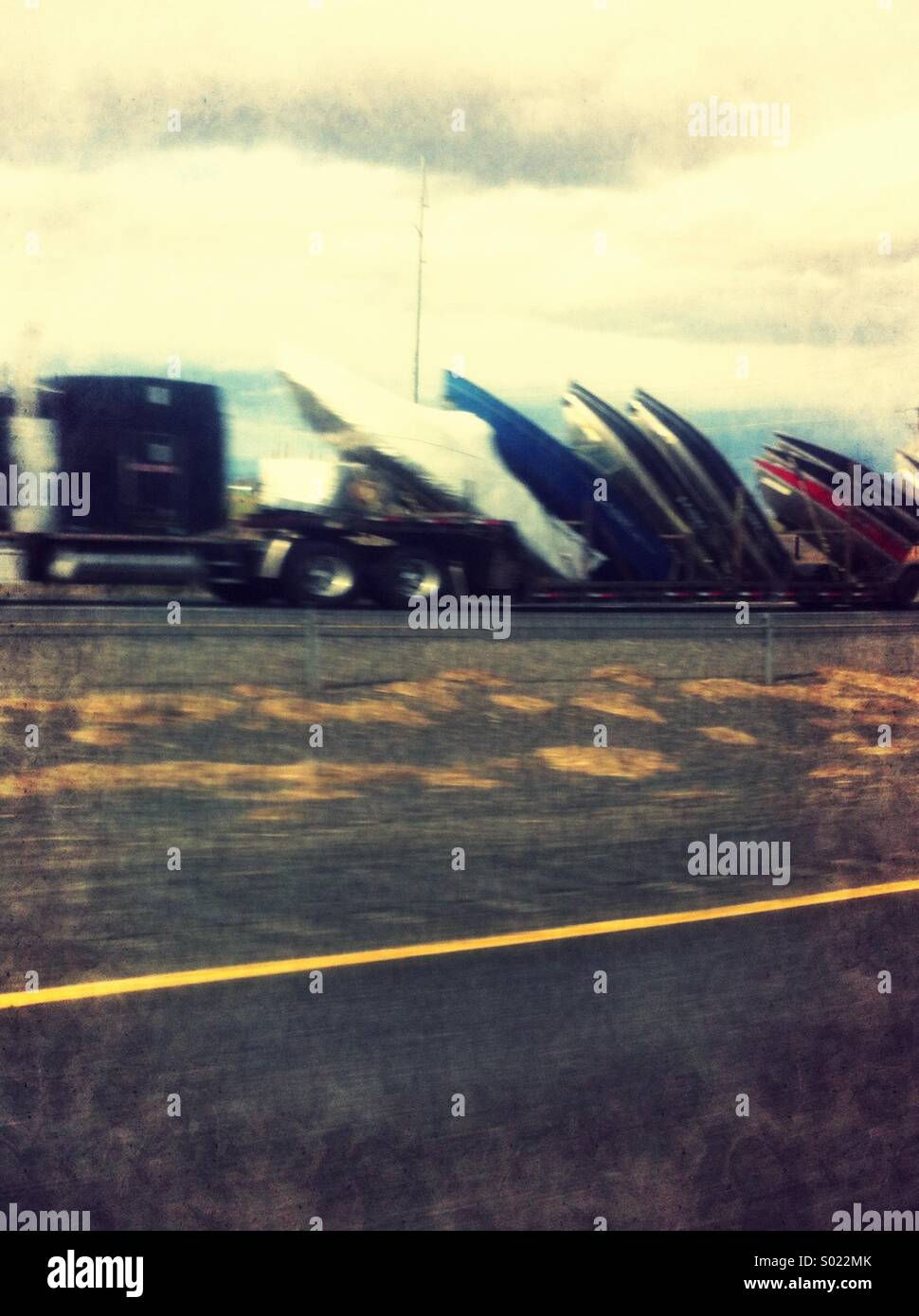 Semi truck hauling private boats on highway Stock Photo Alamy