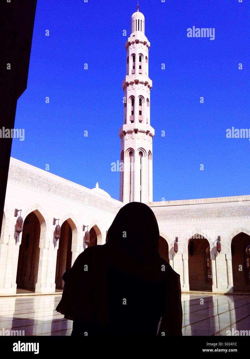 Sultan Qaboos Grand Mosque, Muscat, Oman, with female worshipper - Smartphone Captured Stock Image