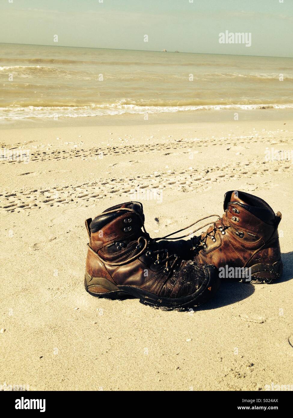 Boots on the beach Stock Photo Alamy