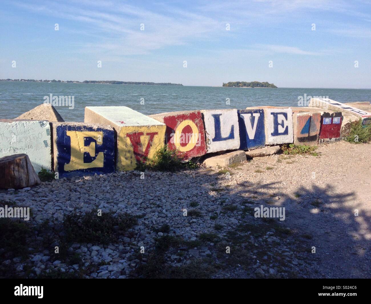 Break wall blocks with the letters EVOLVE painted Stock Photo