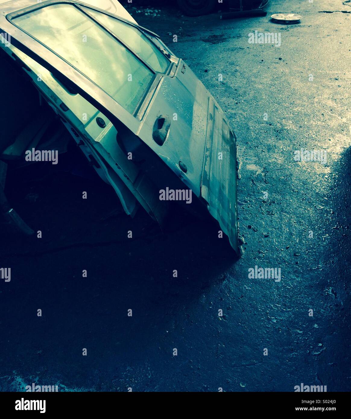 Pile of car doors stacked in a scrapyard. - Smartphone Captured Stock Image