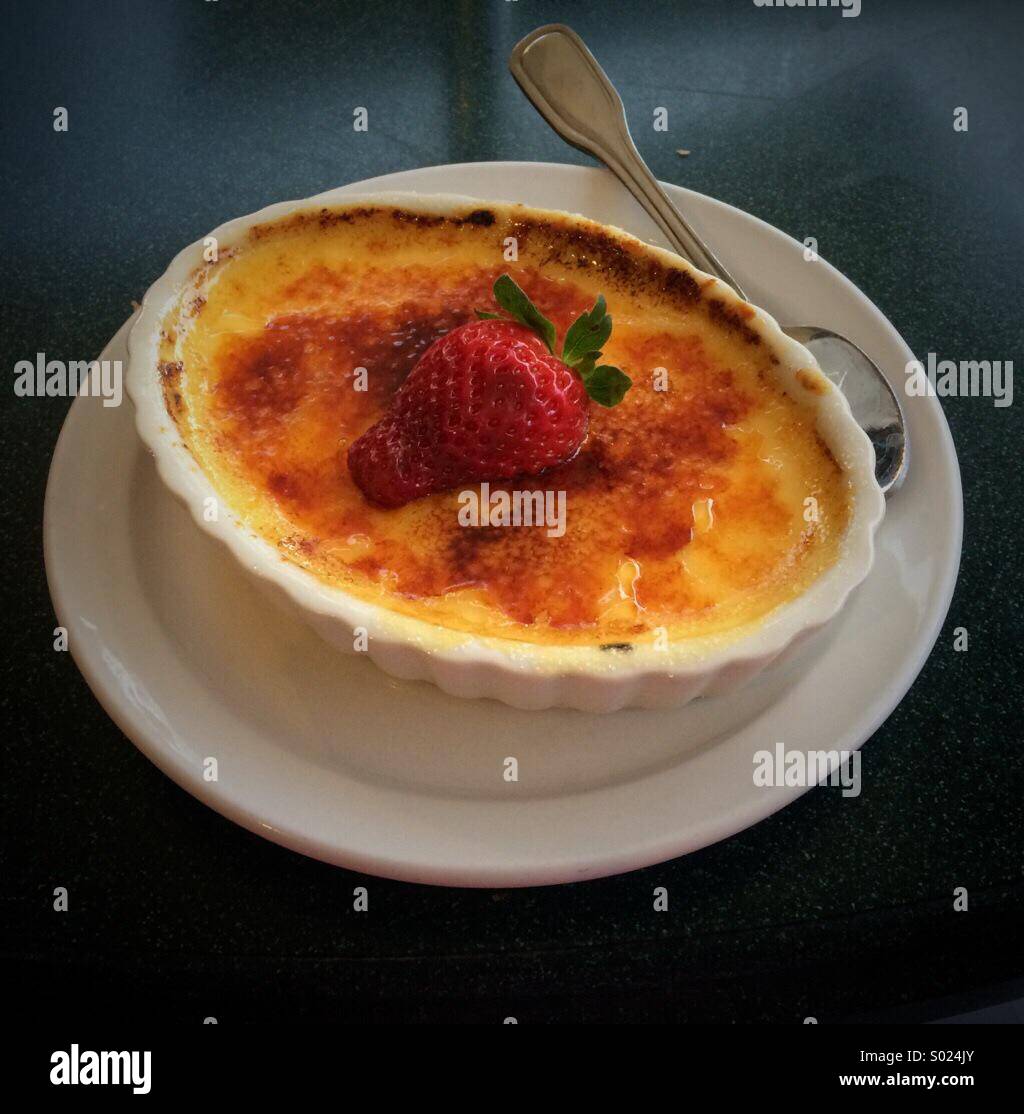 Creme brûlée dessert with a strawberry on top - Smartphone Captured Stock Image