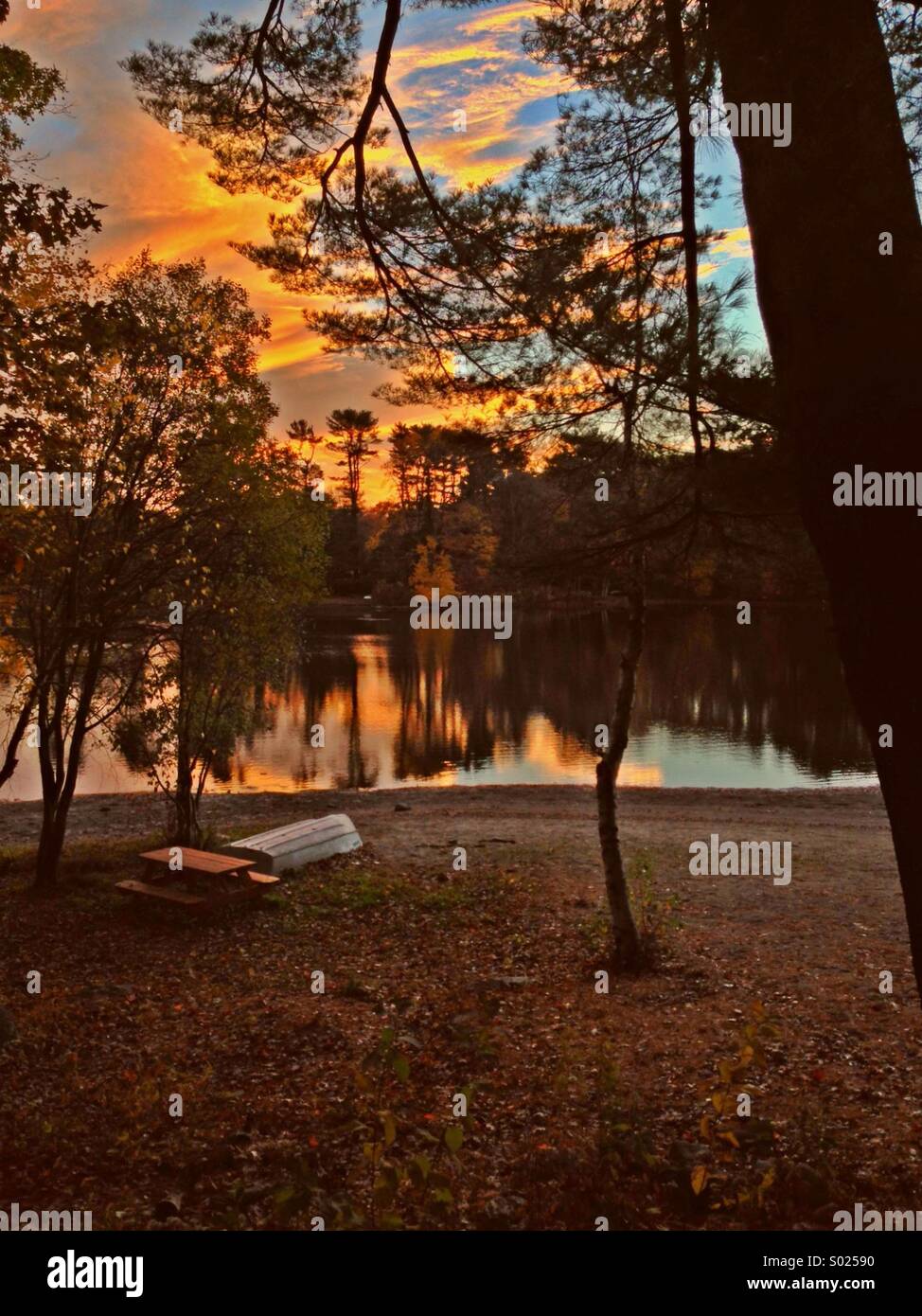 Sunset on Canoe Brook Lake, Trumbull, CT, park bench, canoe Stock Photo