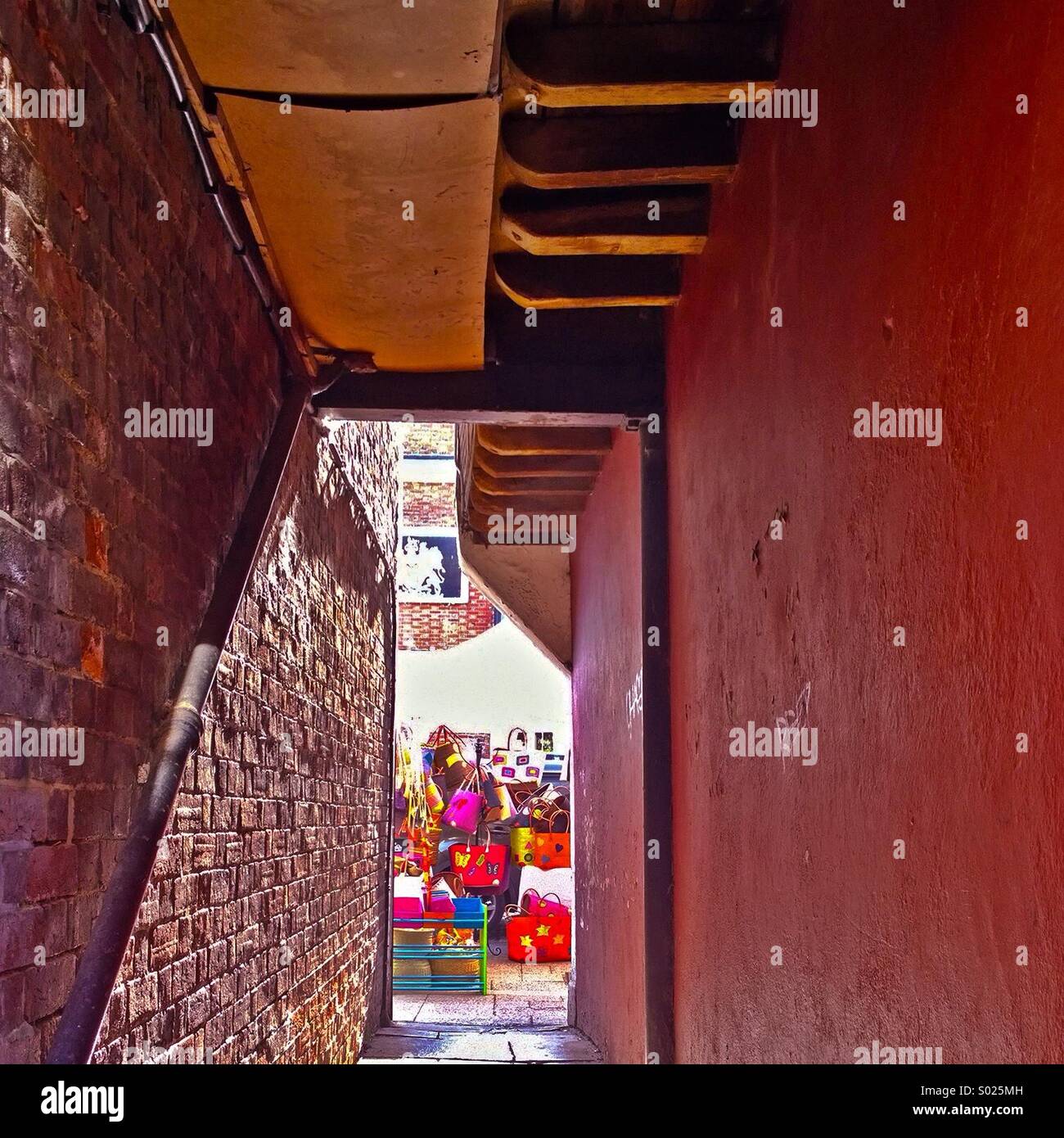 Red! Red painted alley with the word 'red' scrawled in graffiti on the wall Stock Photo