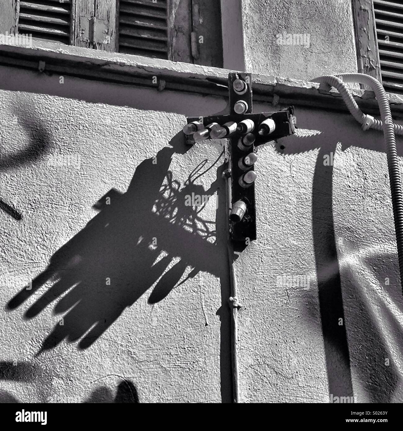 An old broken cross with lightbulbs outside a church in Central Athens, Greece Stock Photo