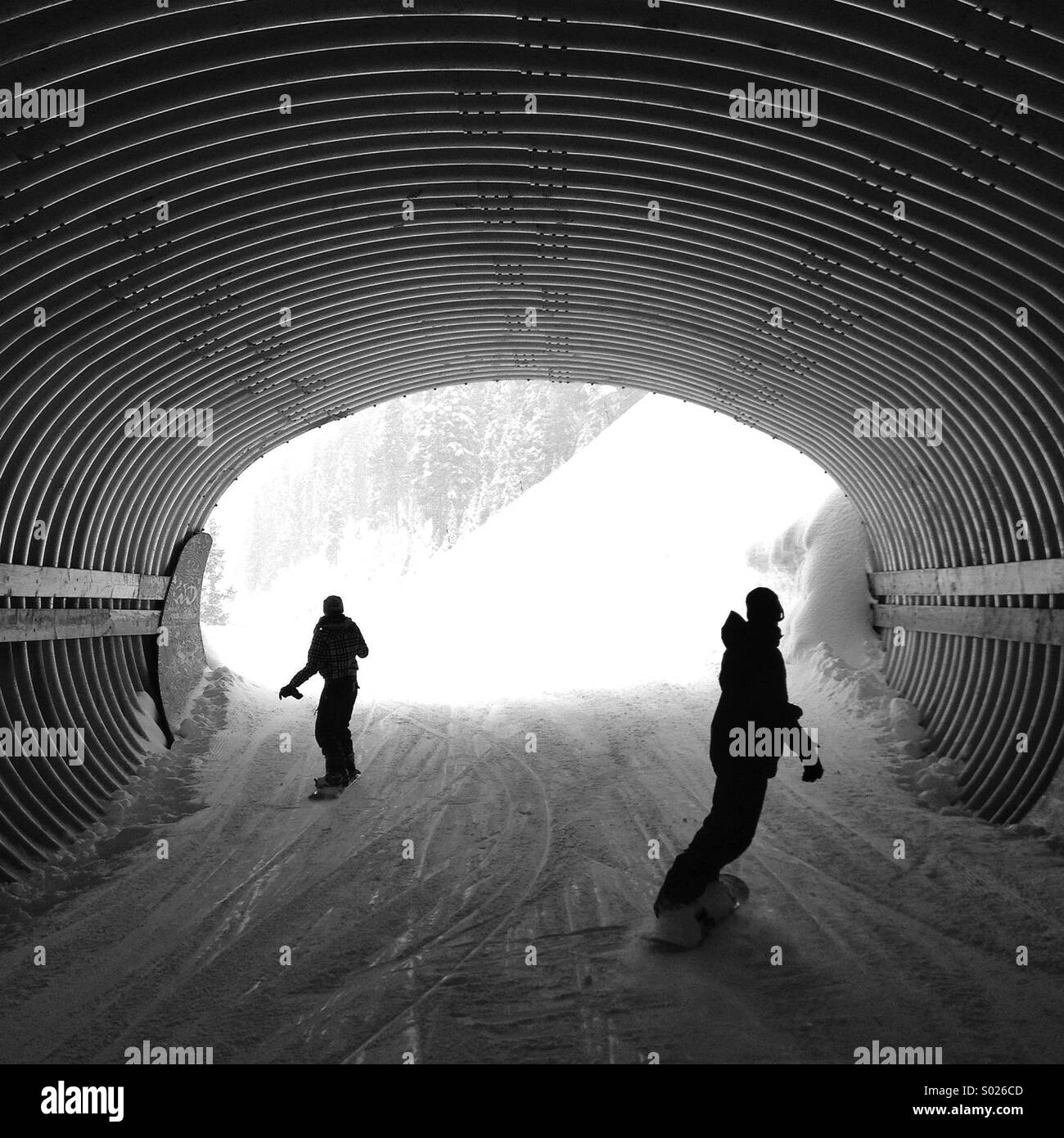 Snowboarders in a tunnel Stock Photo