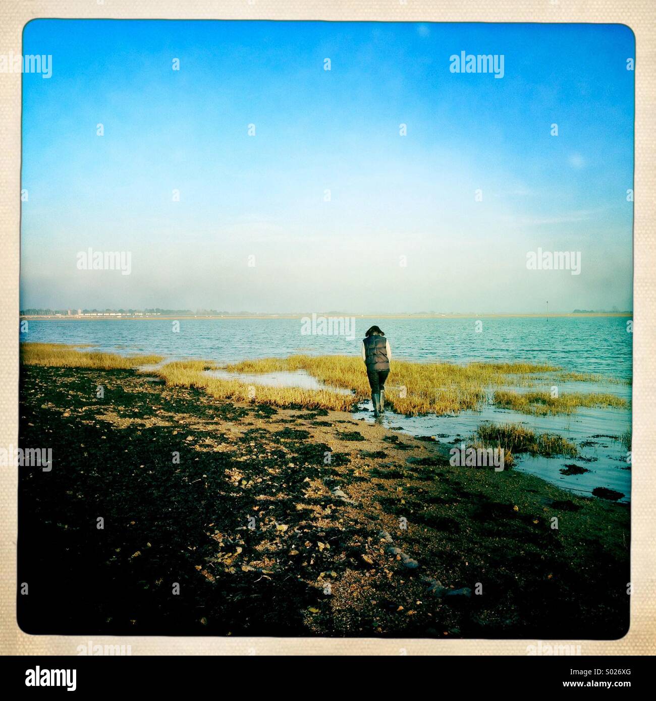Woman walking on foreshore, Chichester Harbour, UK - Smartphone Captured Stock Image