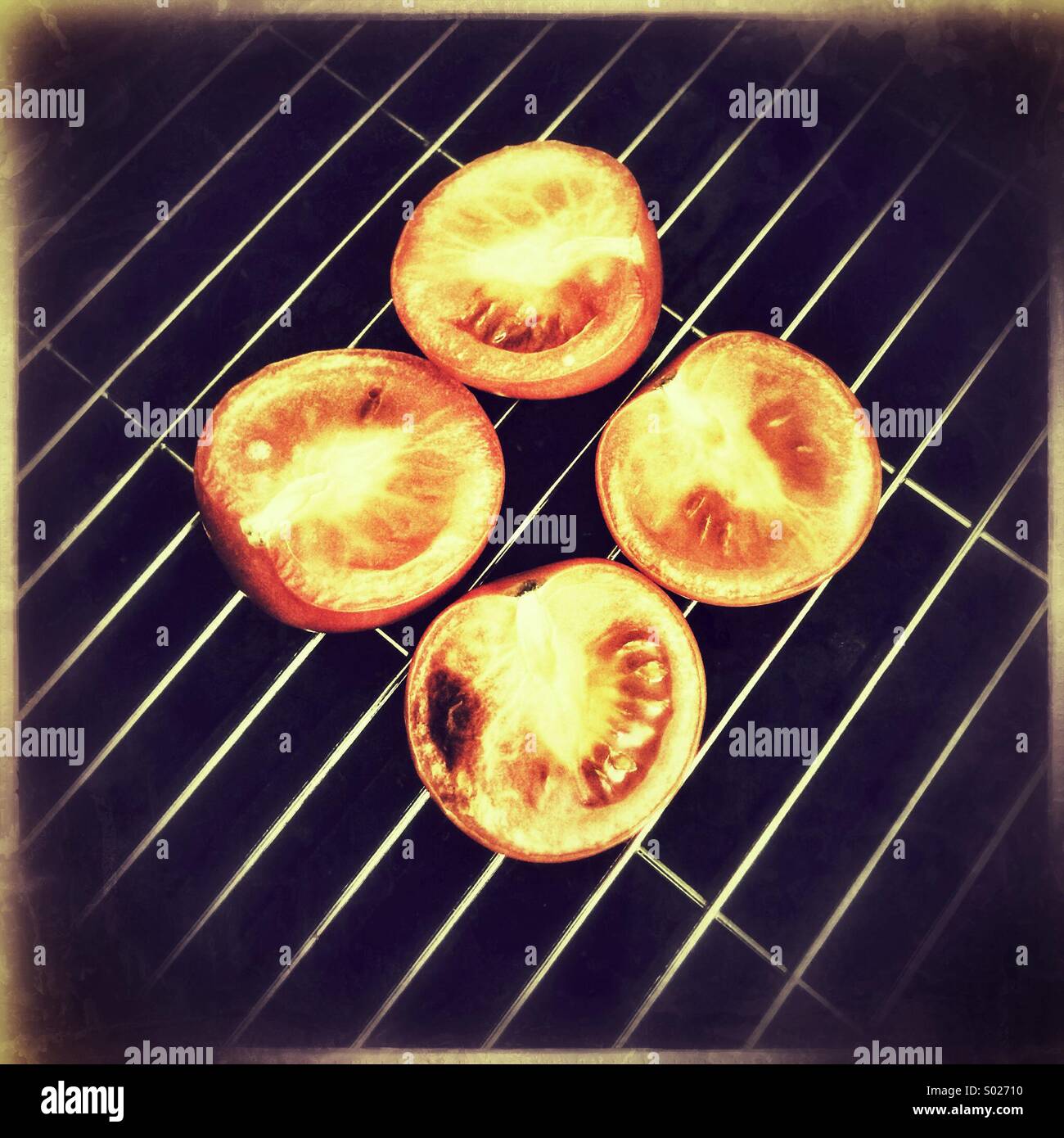 Tomatoes on grill pan Stock Photo