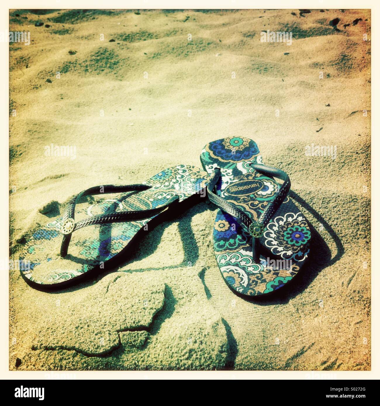 Flipflops on the beach Stock Photo - Alamy