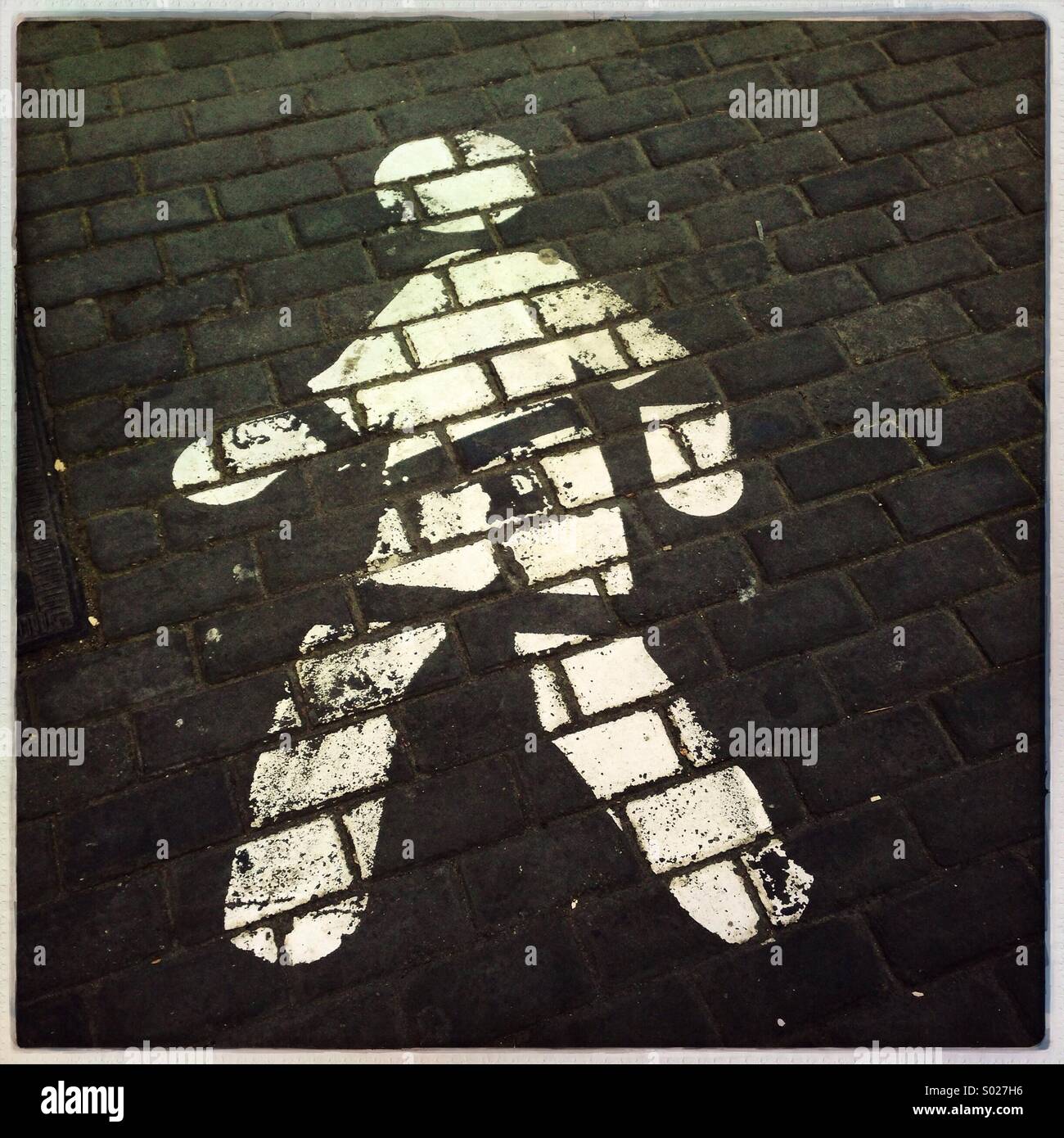 Walking sign on pavement stone streetside - Smartphone Captured Stock Image