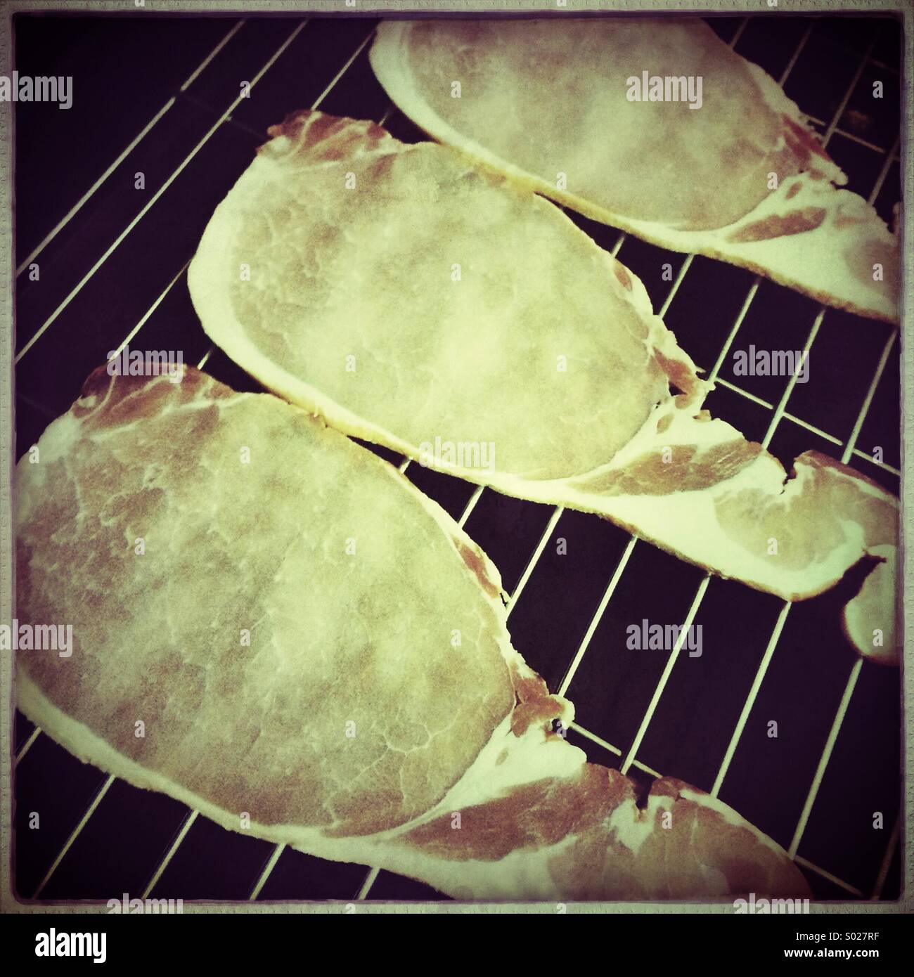 Bacon rashers on grill rack Stock Photo Alamy