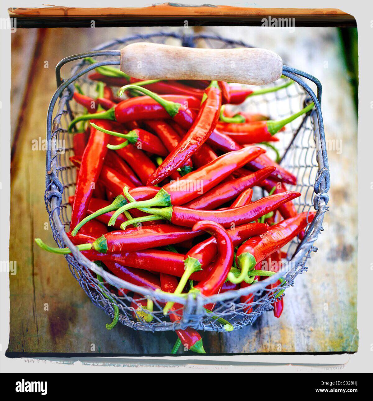 Basket Of Red Hot Chilli Peppers Stock Photo - Alamy