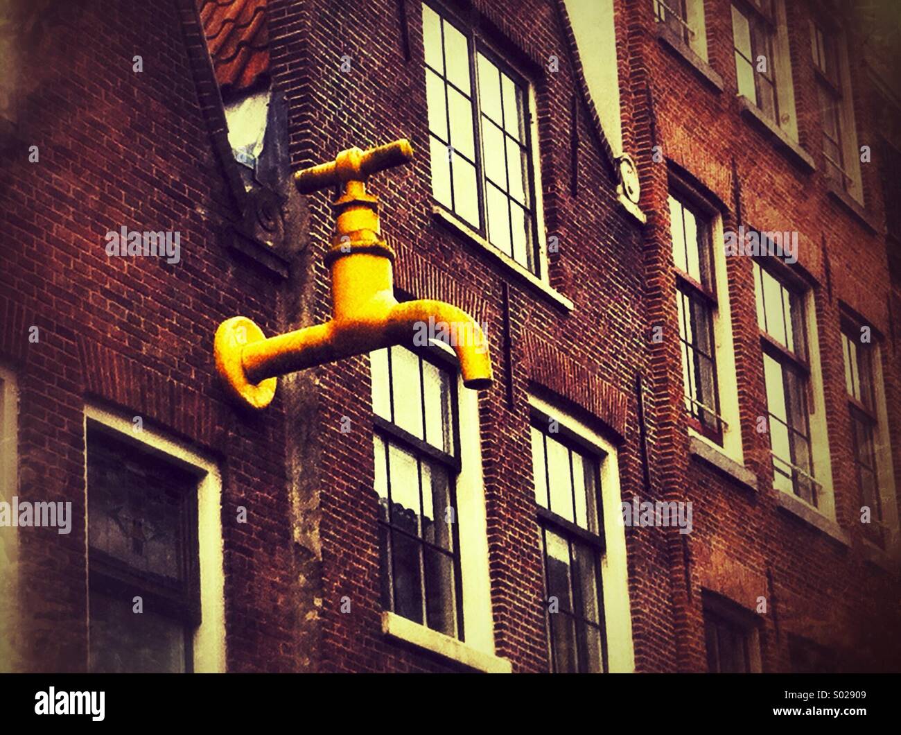 Sculpture on the facade of a house in a suburb of Amsterdam - Smartphone Captured Stock Image