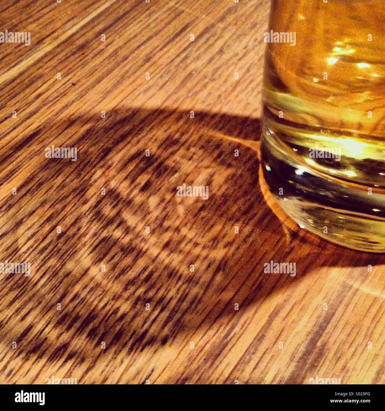 Beer reflection on a wooden table - Smartphone Captured Stock Image