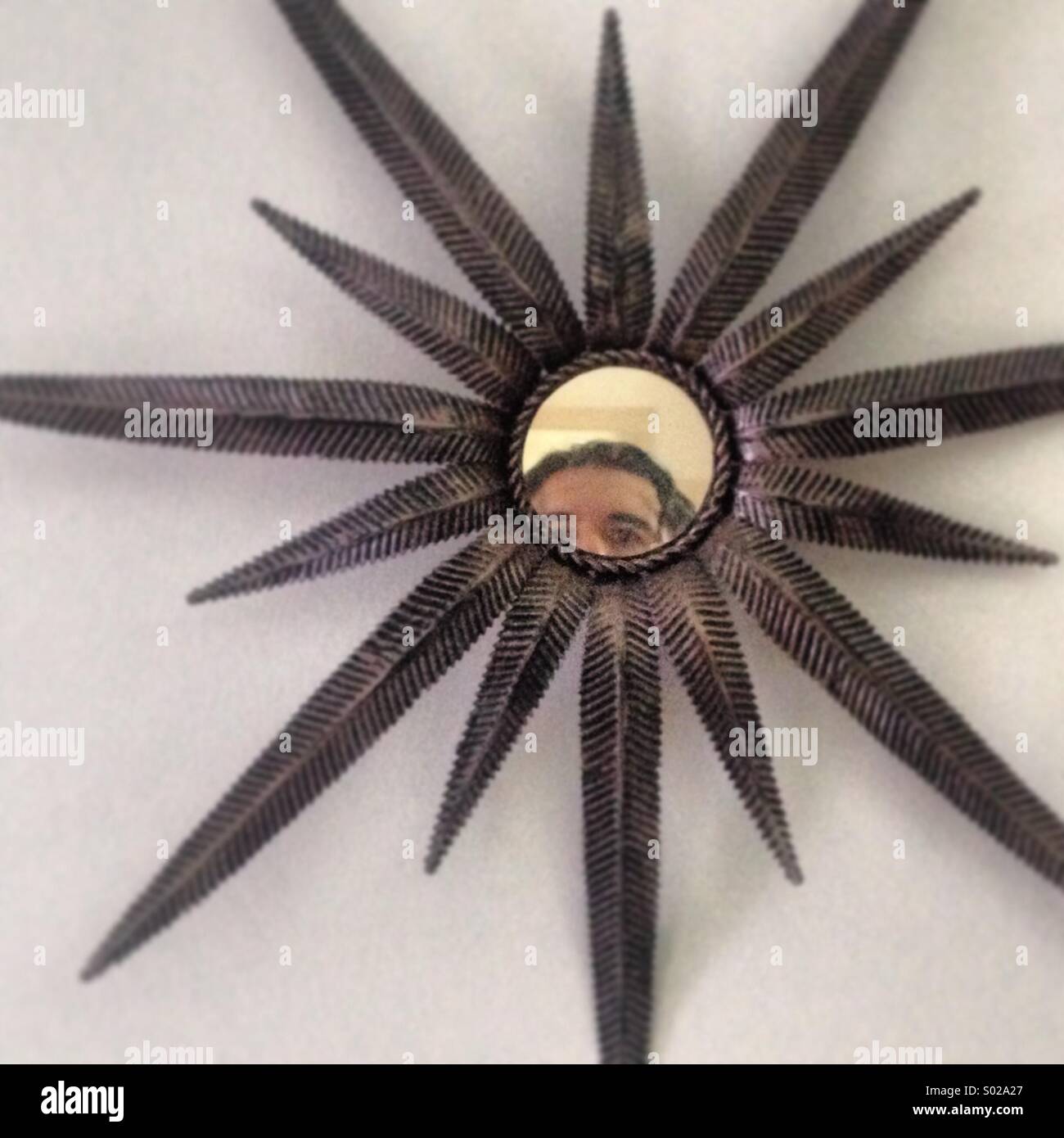 Self-portrait in a star shaped mirror in the home of artist Balduino Roman Macias in Prado del Rey, Cadiz, Andalusia, Spain - Smartphone Captured Stock Image