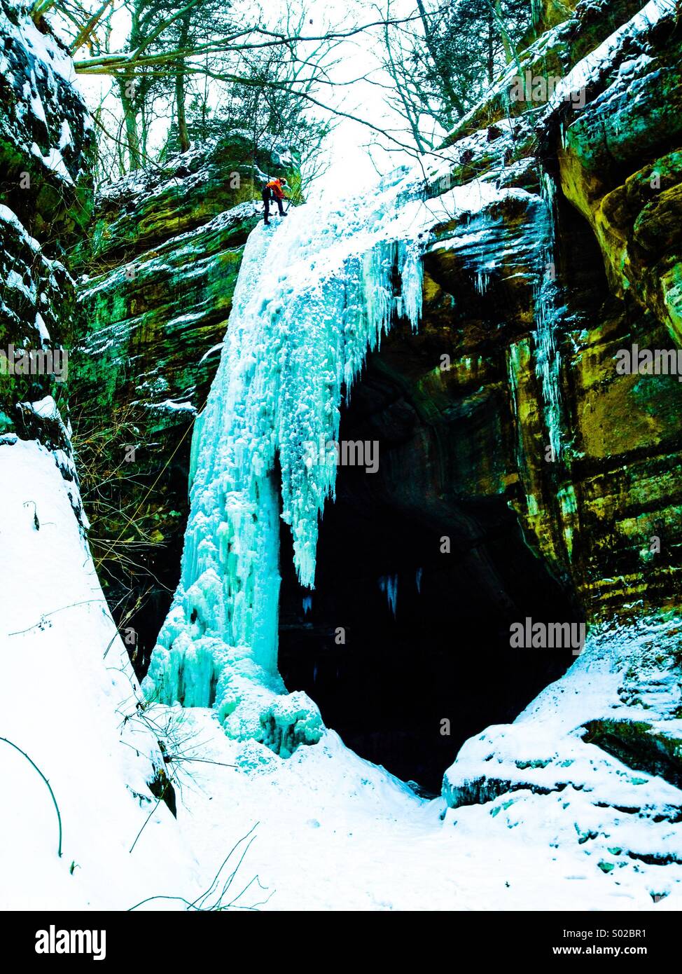 Frozen waterfall with ice climber at top. Starved Rock State Park Illinois Stock Photo