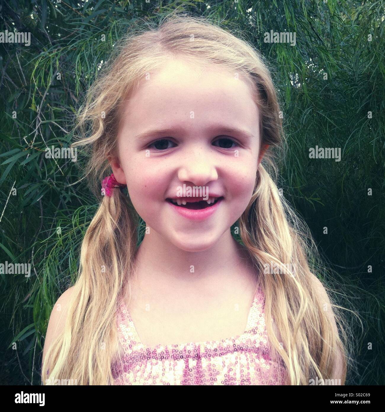 Little smiling girl missing two front teeth Stock Photo