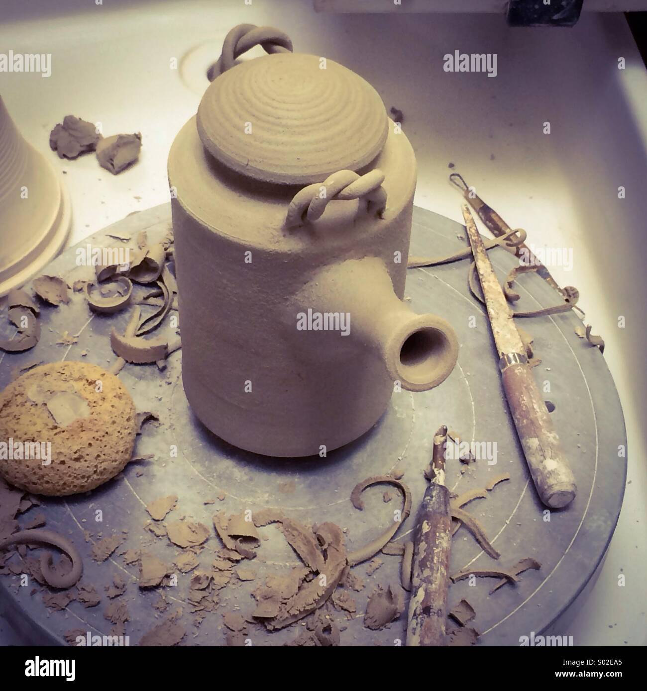 Potter making teapot out of clay on the wheel - Smartphone Captured Stock Image