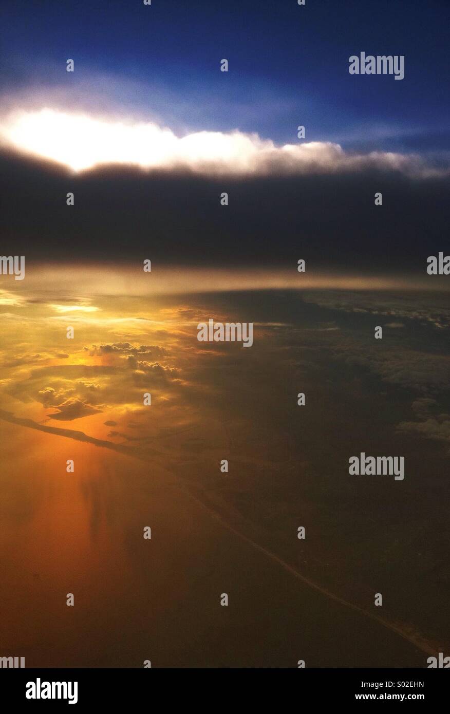 The East Coast of the United States from an airplane, with a beautiful sunset over the land and Atlantic Ocean. Stock Photo