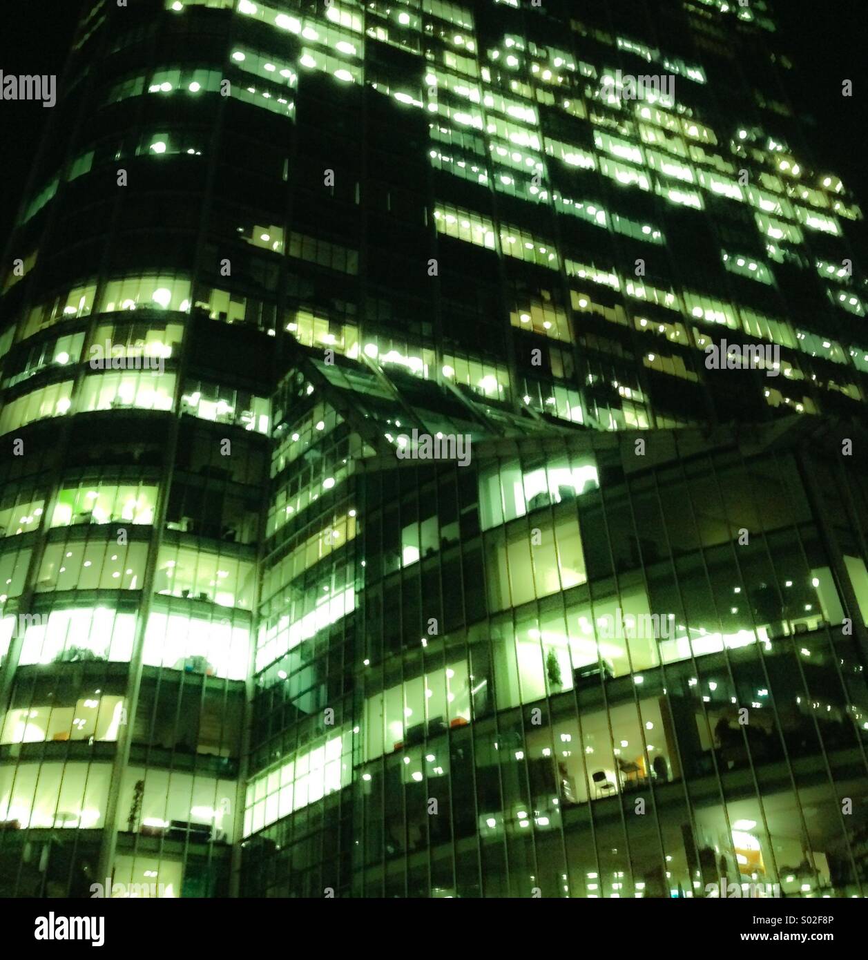 Office block with lights on Stock Photo Alamy