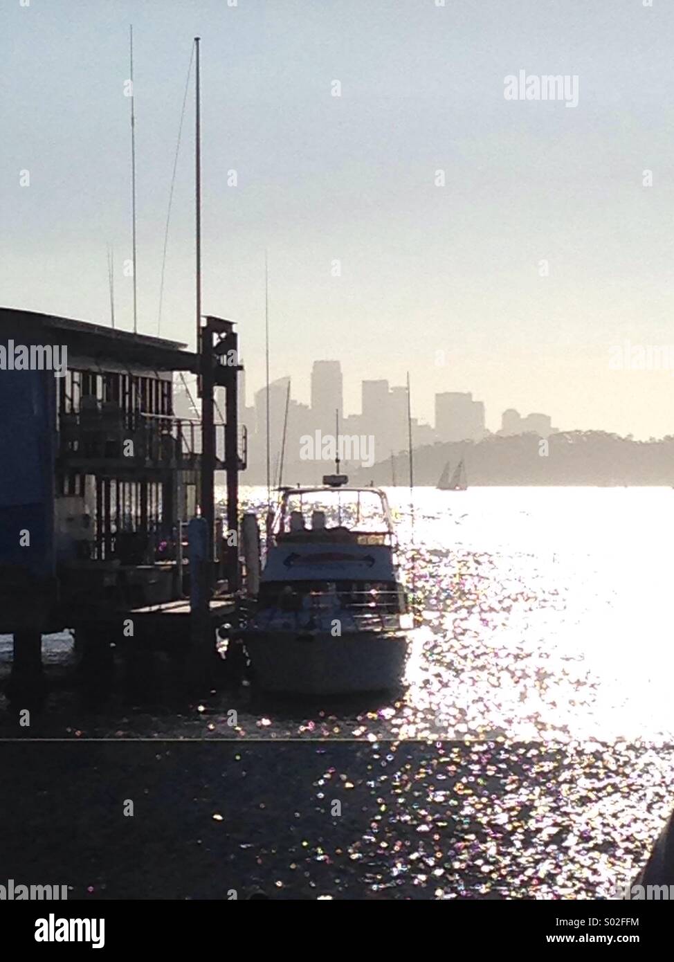 Silhouette of  a boat and the City of Sydney from Doyle's Sydney Bay Australia - Smartphone Captured Stock Image