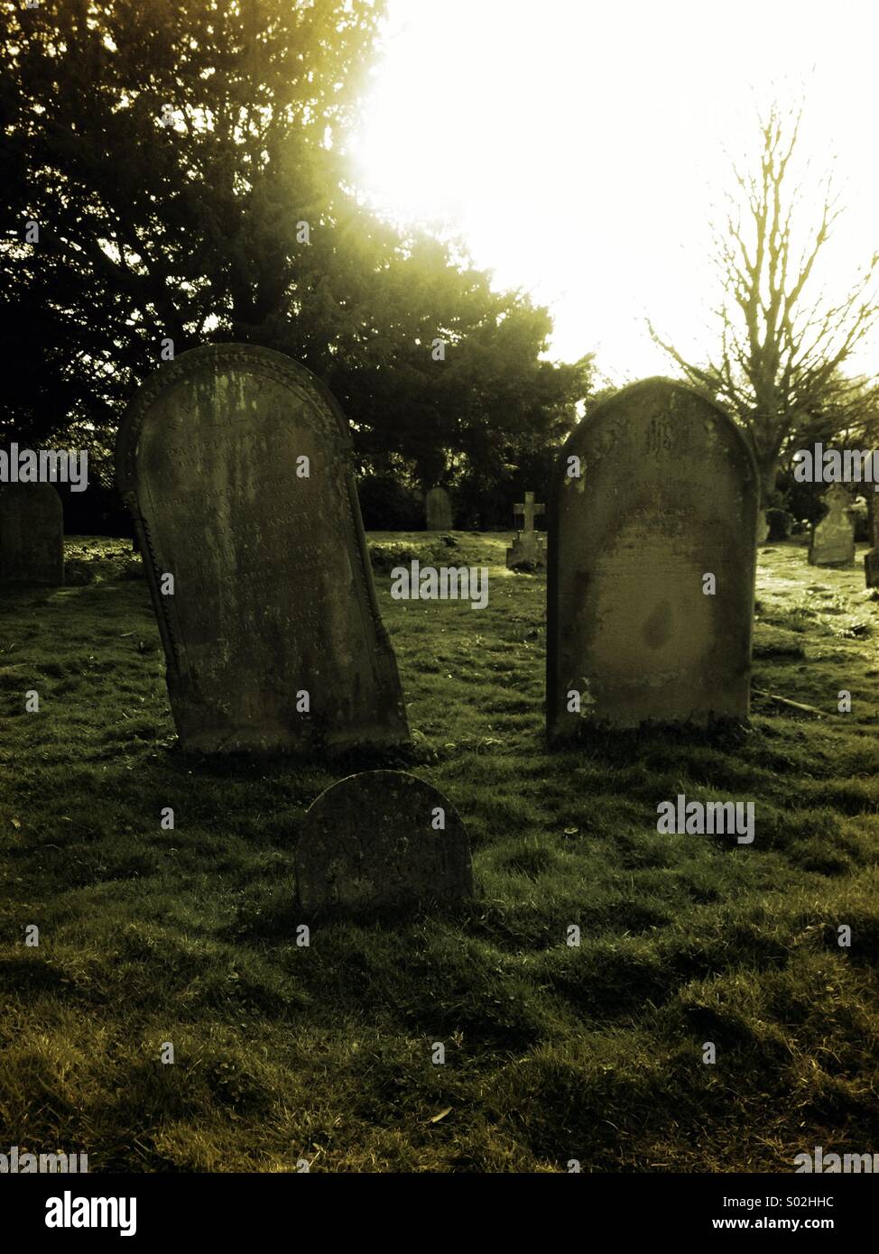 Old family of grave headstones in a rural church yard - Smartphone Captured Stock Image