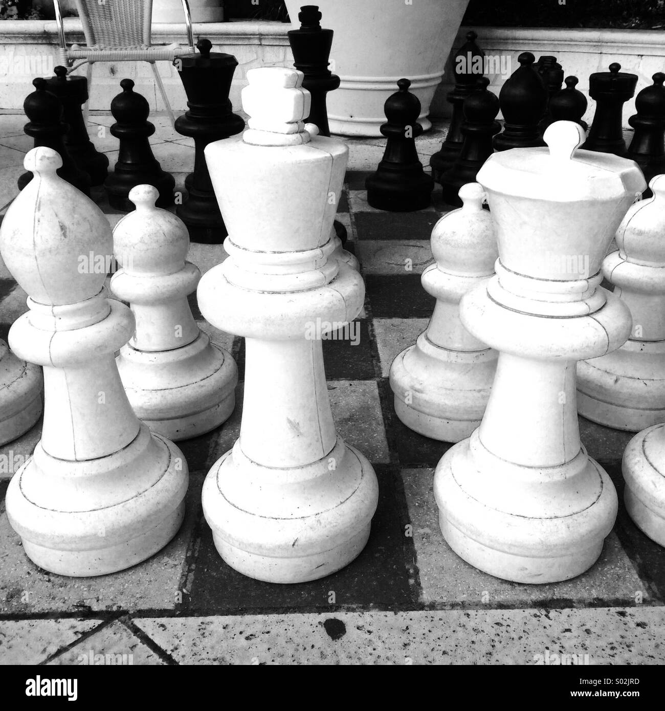 Close up of chess pieces on sidewalk board game - Smartphone Captured Stock Image