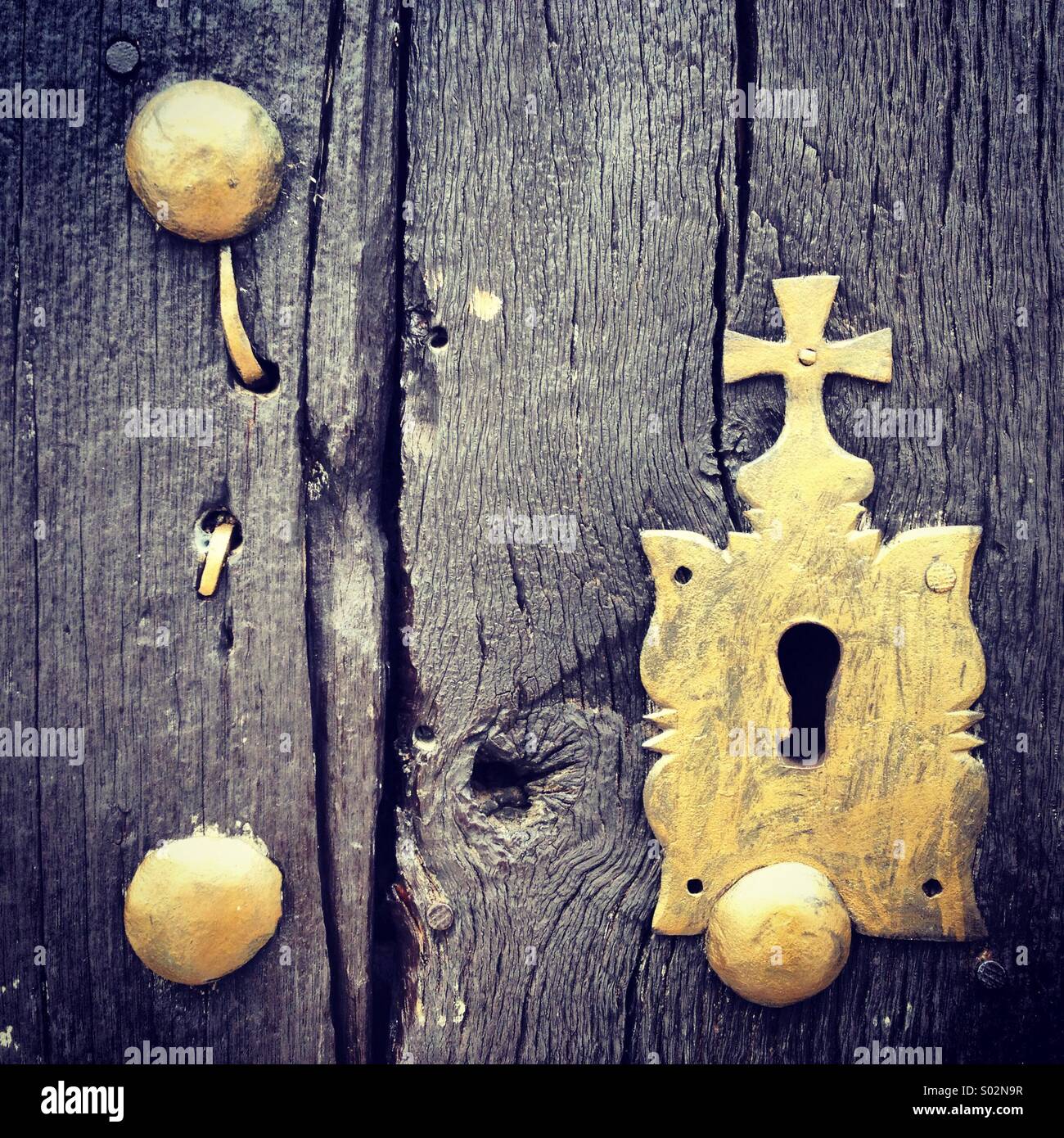 An old golden clock decorated with a cross in a home of Benaocaz, Sierra de Cadiz, Andalusia, Spain - Smartphone Captured Stock Image