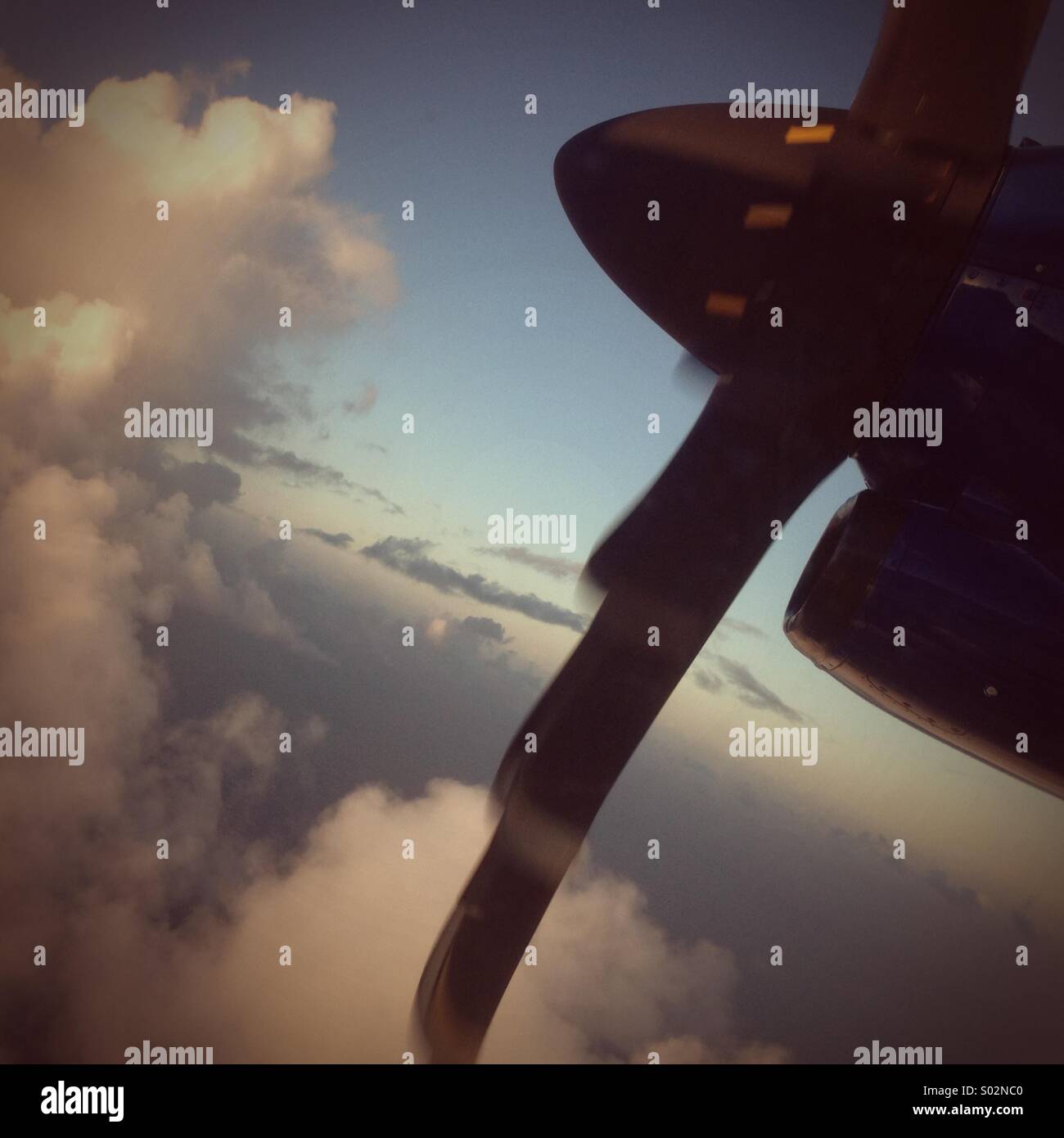 Plane in the sky, clouds and propellers Stock Photo