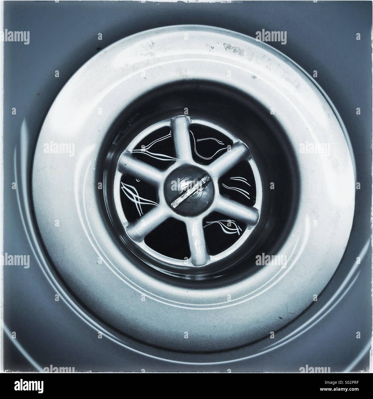 Water running down the plug hole in bathroom sink - Smartphone Captured Stock Image