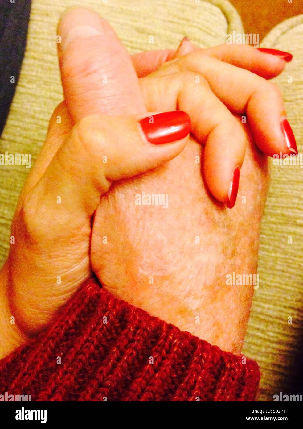 Old man and young woman holding hands detail - Smartphone Captured Stock Image