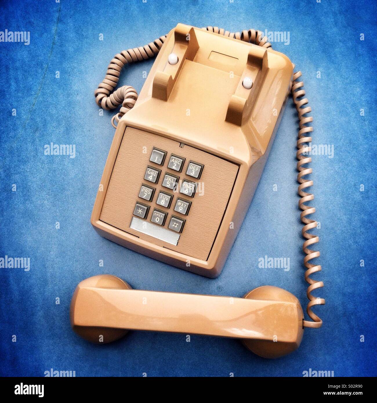 Retro office phone with handset off. Punch button dialing. Stock Photo
