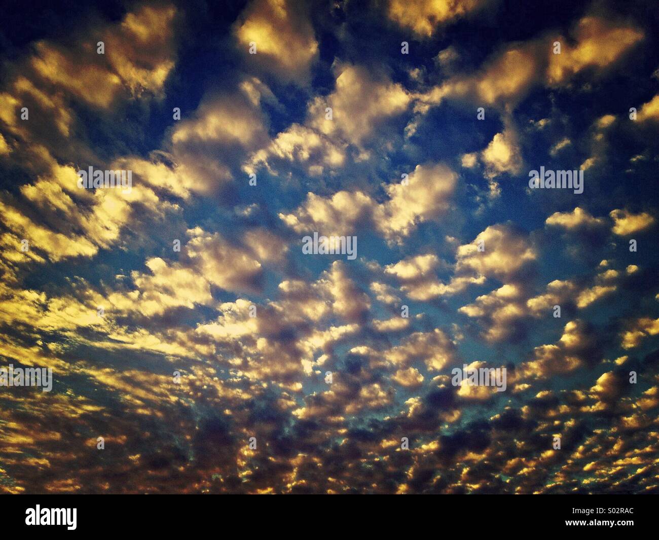 Golden clouds create a pattern in the sky - Smartphone Captured Stock Image