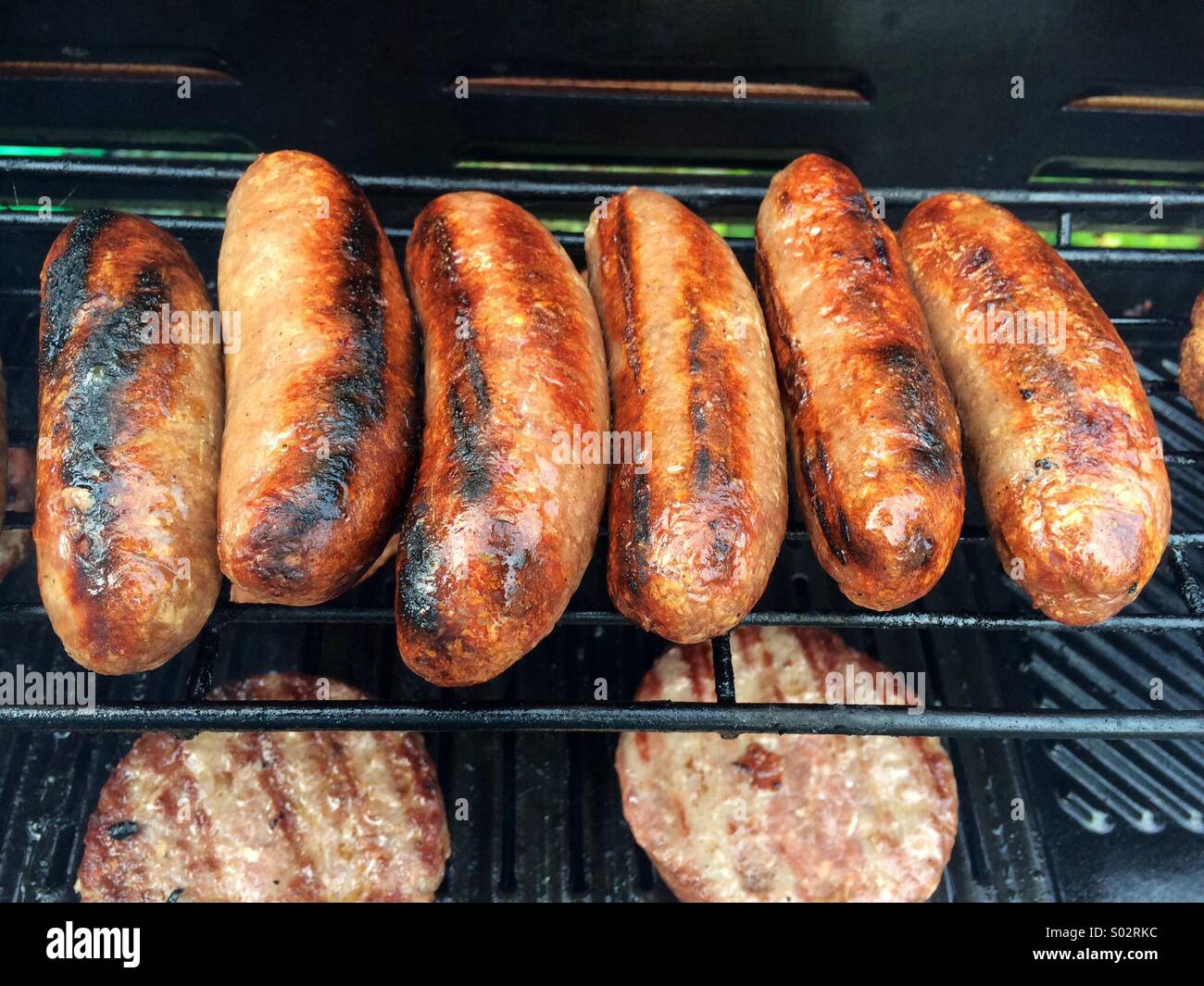 Barbecue sausages and burgers Stock Photo Alamy