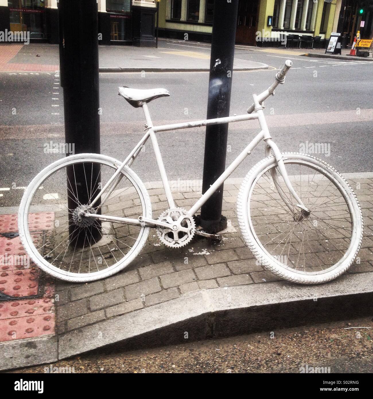 Ghost bicycle - to mark the location where cyclists have been killed in road accidents in central London, a white bicycle is chained up to remind those of the cyclist who passed away Stock Photo