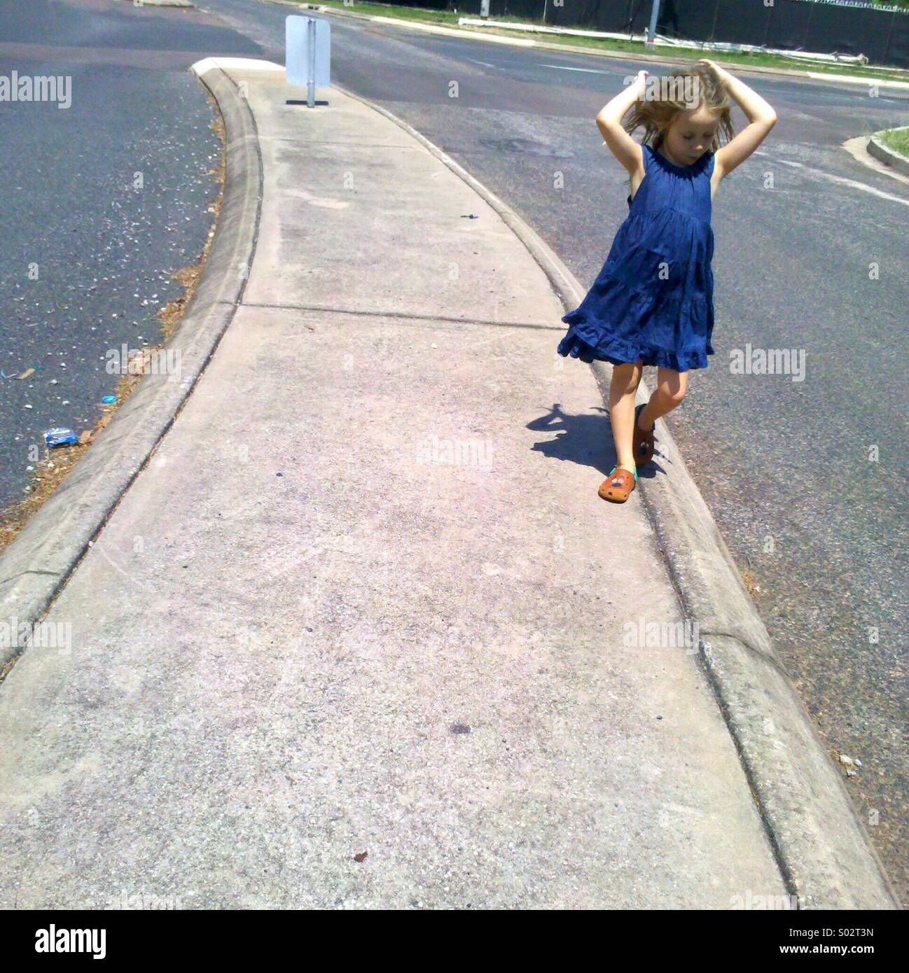 Girl playing in the street. - Smartphone Captured Stock Image